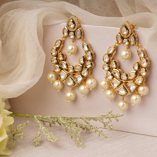 Gold plated kundan earrings with faux pearls and meenakari work at the back.